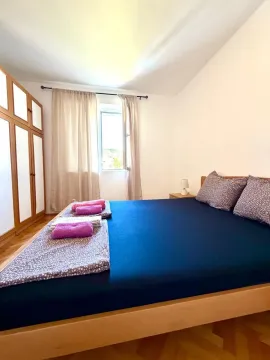 Bedroom with a double bed, wardrobe, and a window. - image 9