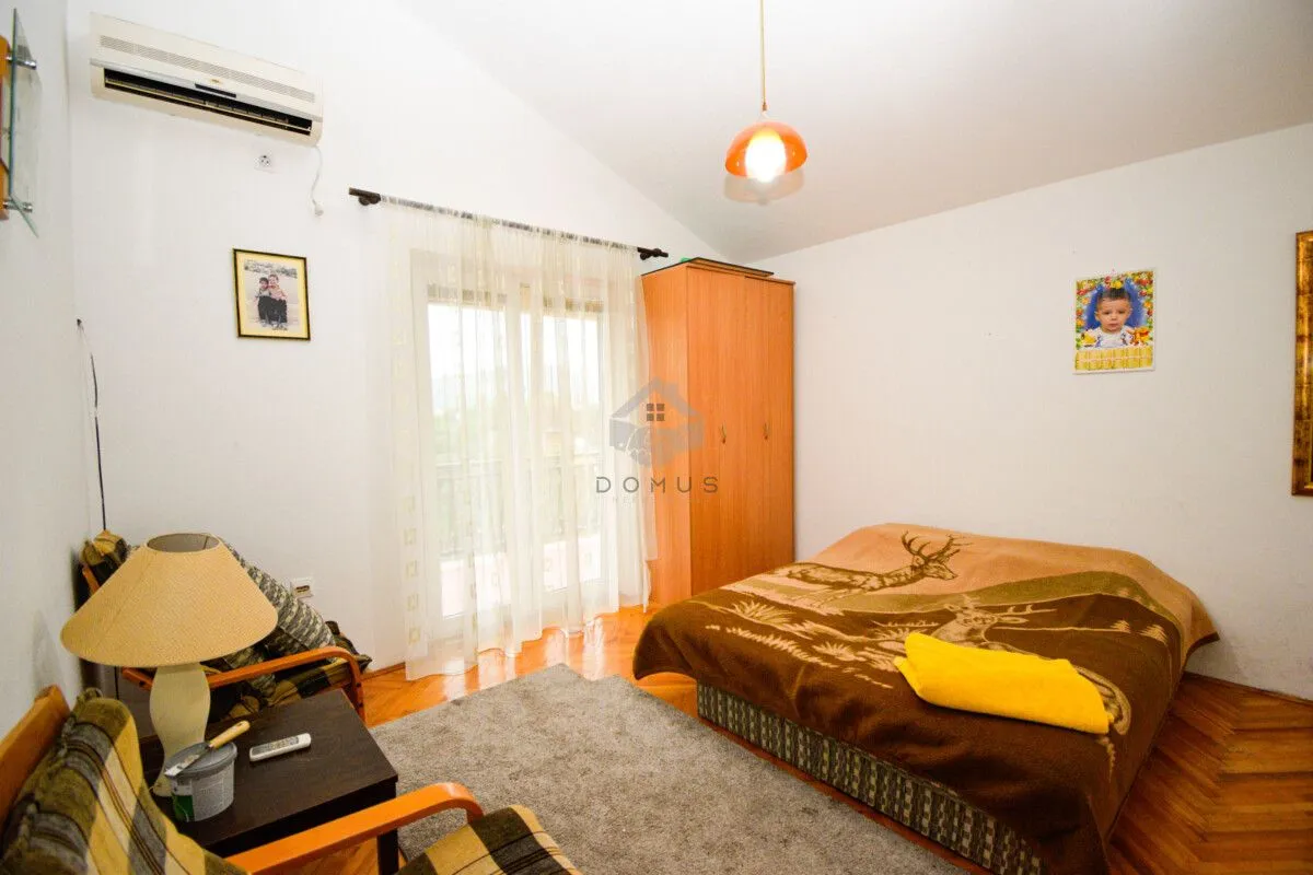 Furnished bedroom with a double bed, wardrobe, and balcony doors.