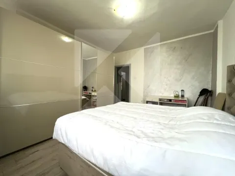 Bedroom with a large double bed and a fitted wardrobe. - image 7