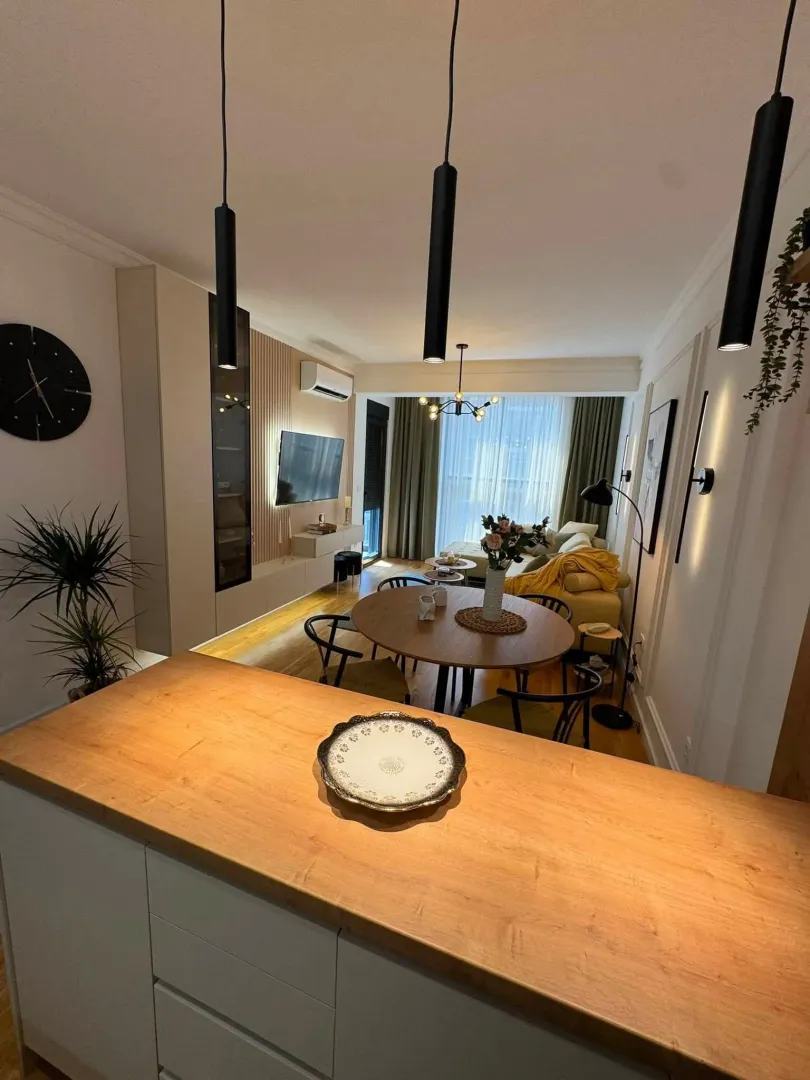 Modern living room connected with the dining area and kitchen.