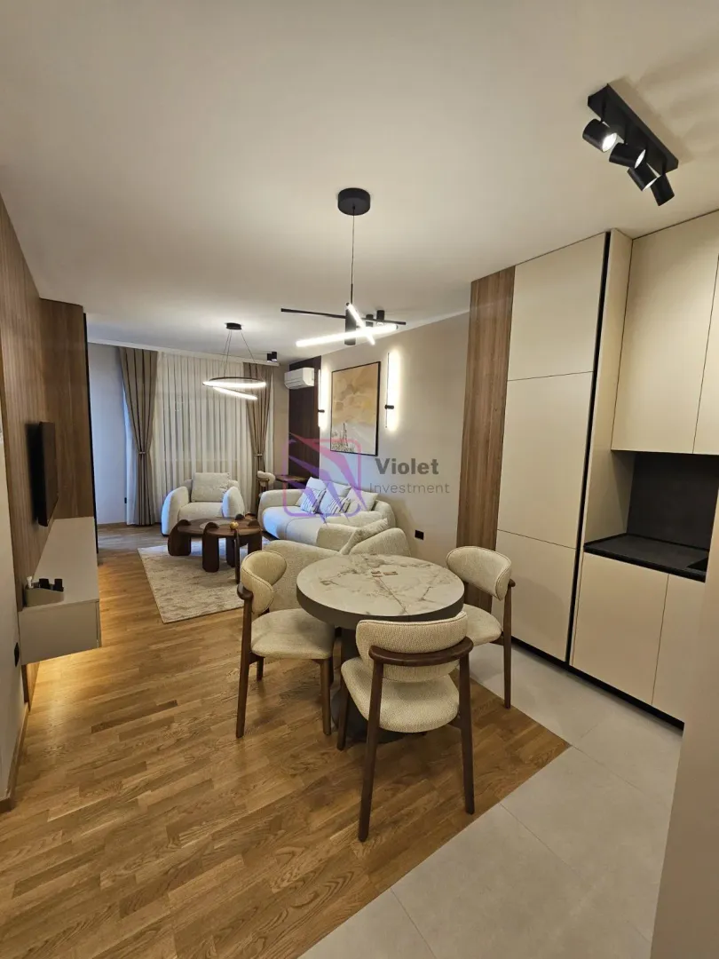 Modern open-plan living room with dining area and kitchen.