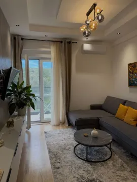 Modern living room with a sofa, coffee table, and access to the terrace. - image 14