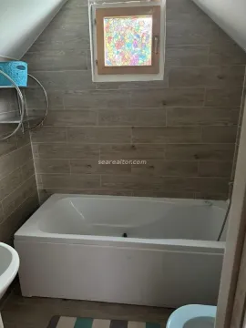 Kupatilo sa kadom i zidnim pločicama u imitaciji drveta pod kosim krovom. - image 7