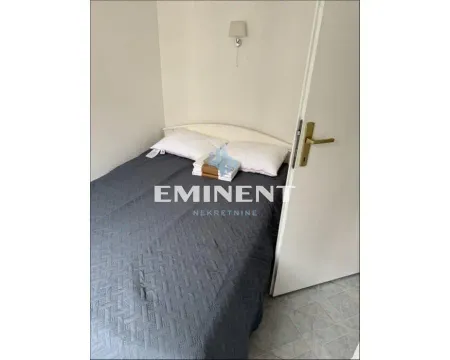 Smaller bedroom with a bed. - image 8