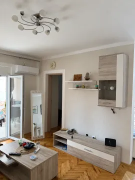 Living room with wooden furniture and access to the terrace. - image 4