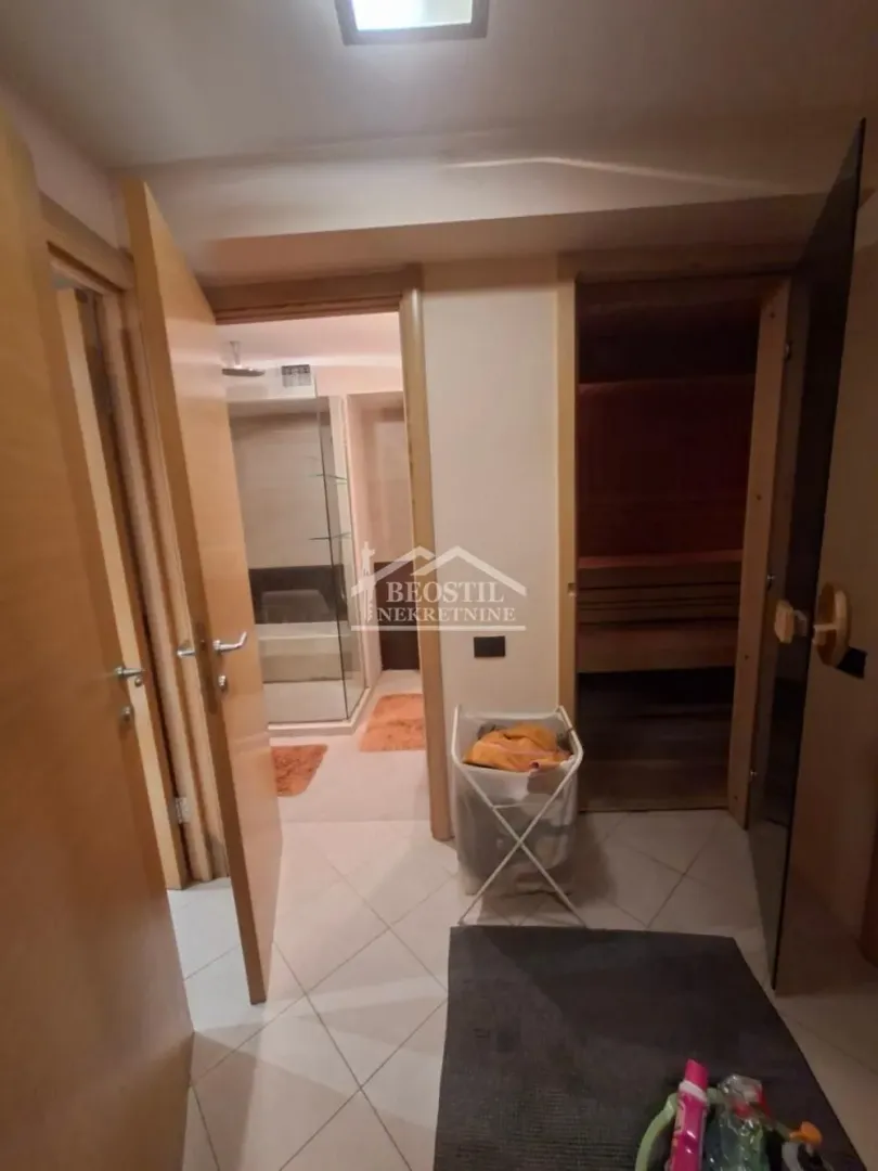 View of the bathroom with a shower cabin and a sauna.