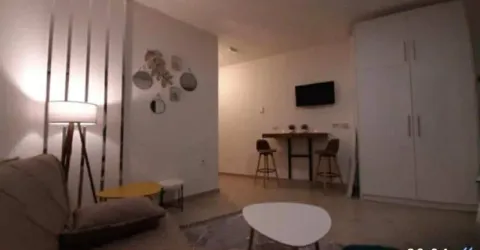 Living room with a sofa, coffee tables, and a wardrobe. - image 6