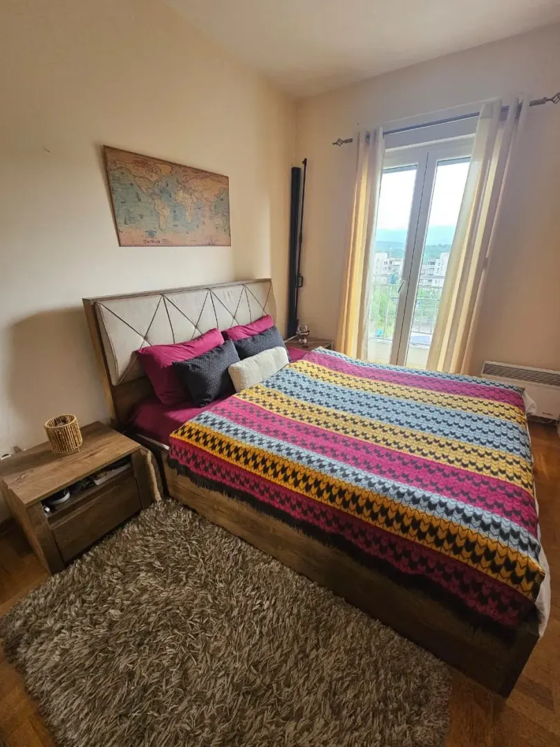 Furnished bedroom with a double bed, bedside tables, and access to the terrace.