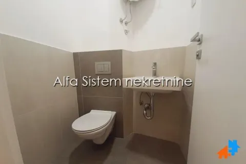Smaller bathroom with a toilet and washbasin. - image 4