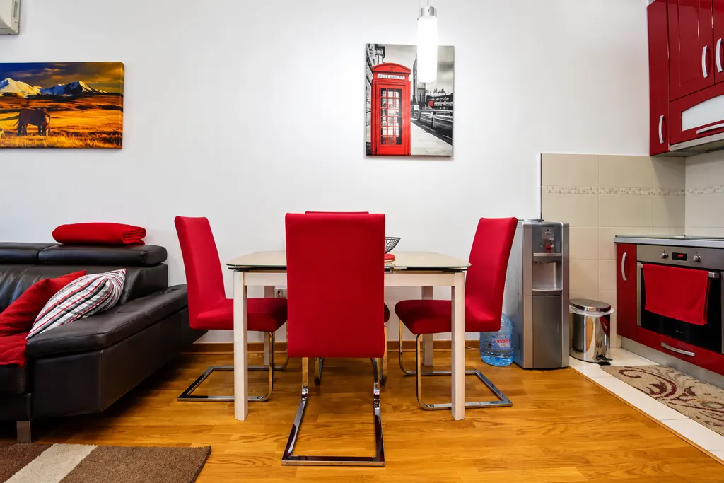 Living room with dining area and kitchen in bright tones.
