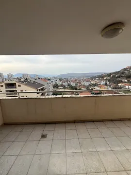 Spacious balcony with a view of the city and surrounding hills. - image 22