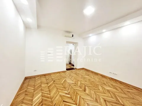 Empty room with hardwood floors and white walls. - image 3