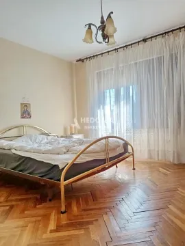 Bedroom with a double bed and parquet flooring. - image 7