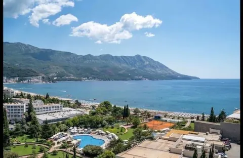 View from the window overlooking the sea, coast, and mountains in the background. - image 2