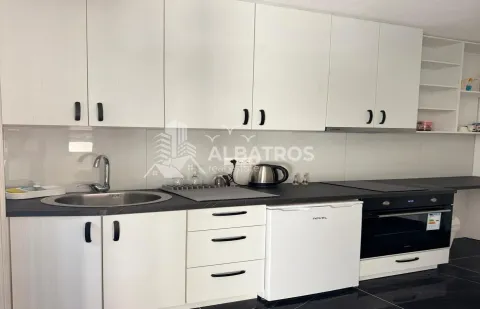 Small kitchen with white cabinets and a built-in oven. - image 5