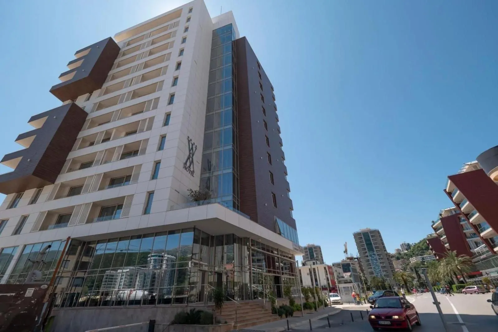 Exterior view of a modern multi-story building with glass elements.