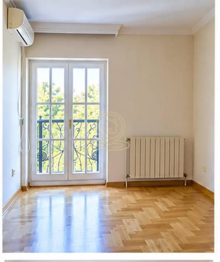 Empty room with hardwood floors, a radiator, and balcony doors.