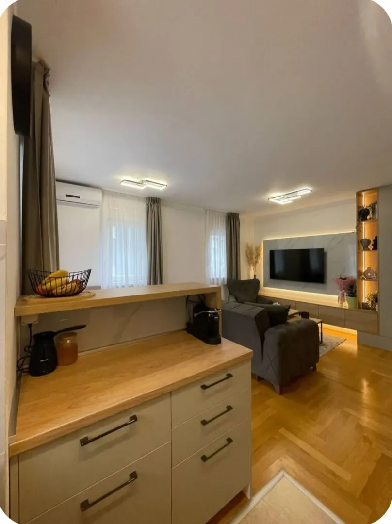 Living room connected with a kitchen counter and seating sofa set.