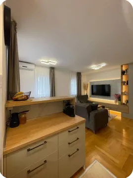 Living room connected with a kitchen counter and seating sofa set. - image 16