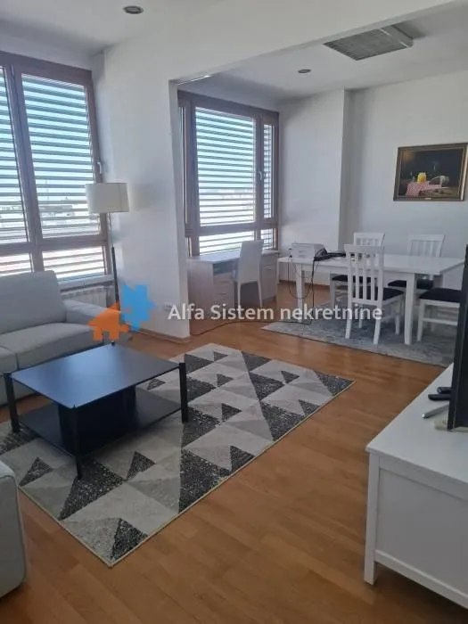 Spacious living room with a dining area and large windows.