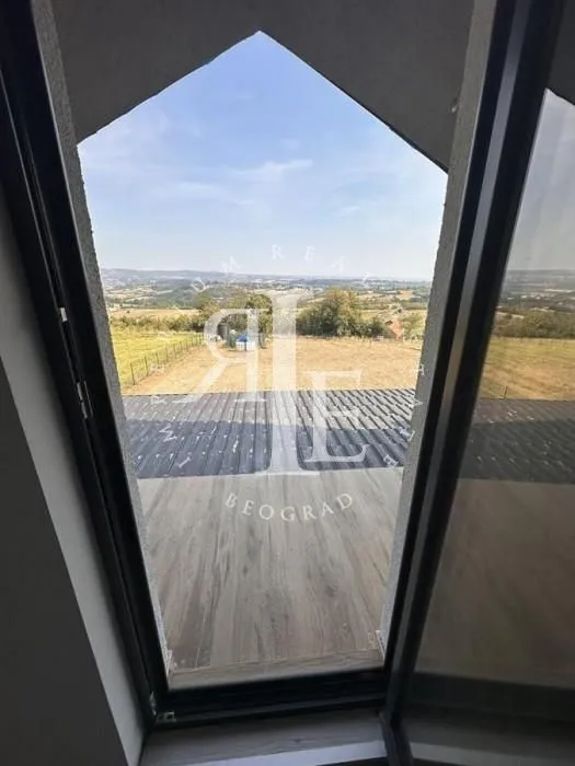 View through a large glass surface onto nature and the surrounding landscape.