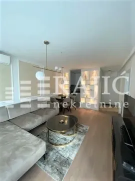 Modern and bright living room with a sofa and dining area. - image 10