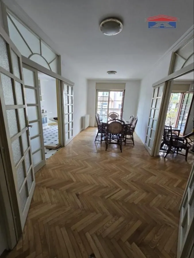 Spacious living room with dining area and hardwood flooring.