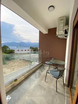 Covered terrace with outdoor seating and a sea view. - image 7
