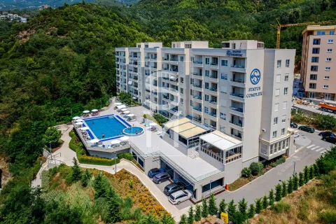 Aerial view of a residential complex with a swimming pool and parking. - image 2