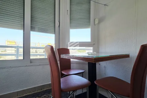 Enclosed balcony with a dining table and chairs by the windows. - image 18
