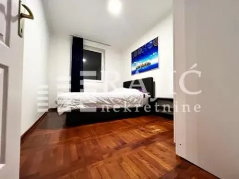 Smaller bedroom with a double bed and parquet flooring. - image 7