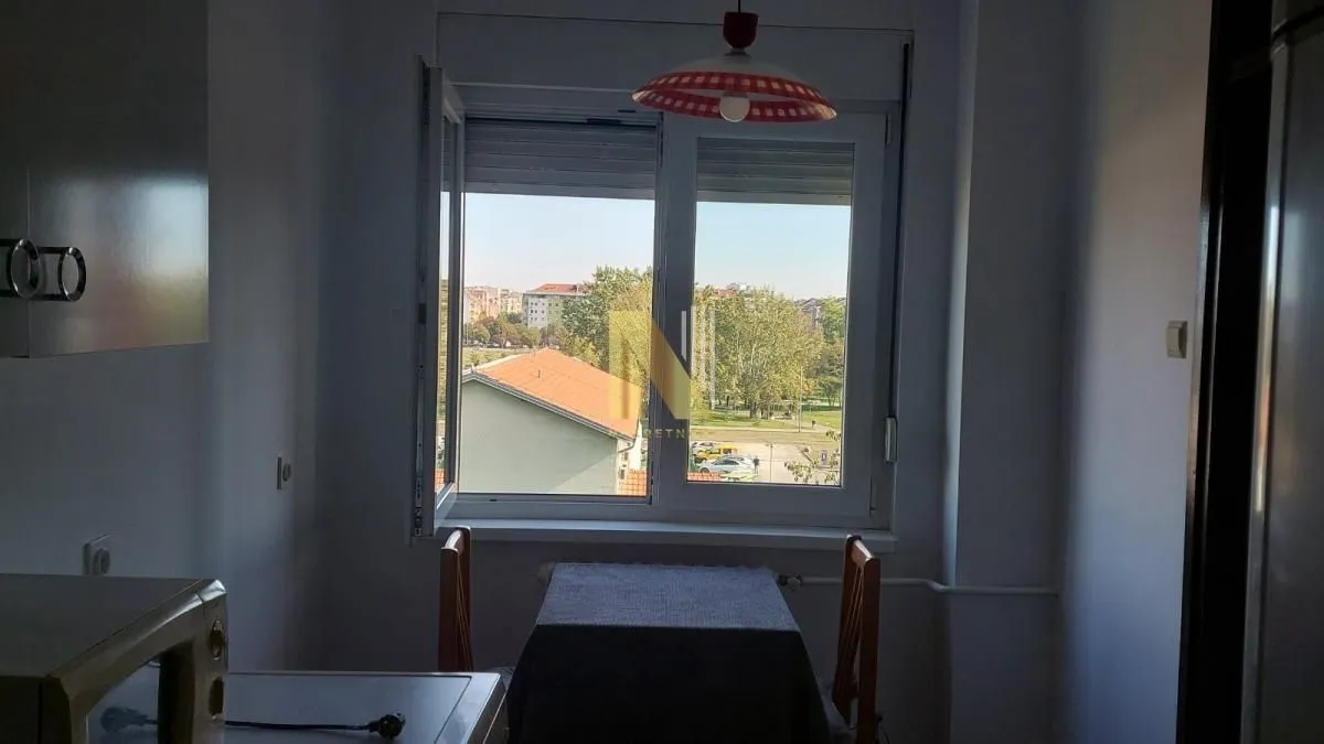 Smaller dining area with a table and a window overlooking the city.