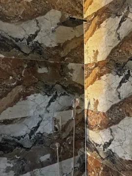 Modern shower with marble tiles in a bathroom. - image 10