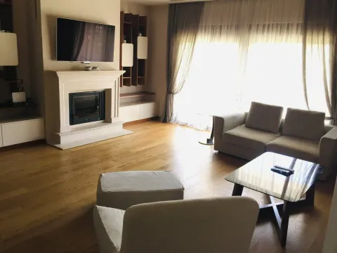 A bright living room featuring a fireplace and seating area. - image 4