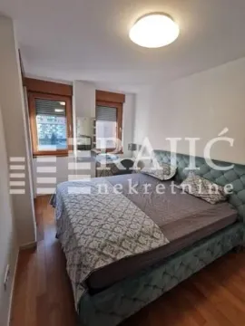 Furnished bedroom with a double bed and windows. - image 2