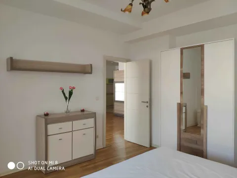 Bright bedroom with a modern wardrobe and chest of drawers. - image 5