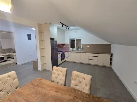Modern kitchen with built-in appliances and a dining table in the attic. - image 4