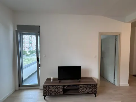 Living room with a TV stand and access to the terrace. - image 3