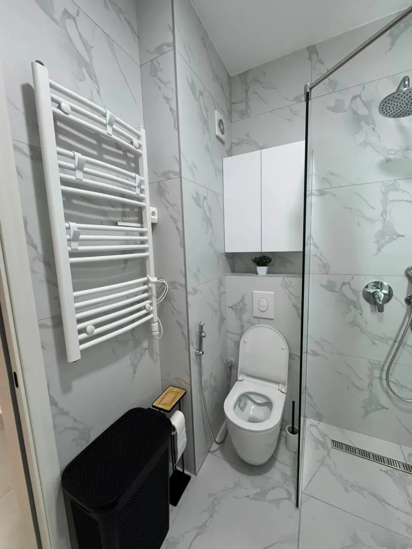 A modern bathroom with a walk-in shower and white sanitaryware.