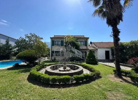 Exterior of the house with a landscaped yard, swimming pool, and fountain. - image 4
