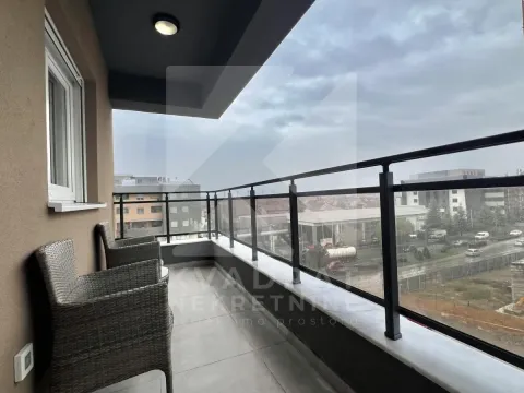 Covered balcony with seating furniture and a view of the surroundings. - image 5