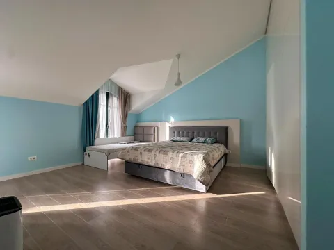 Spavaća soba sa bračnim krevetom, kosim plafonom i plavim zidovima. - image 11