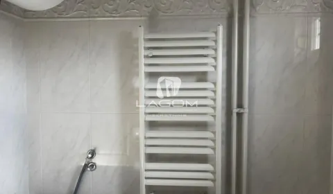 White towel radiator in a tiled bathroom. - image 18