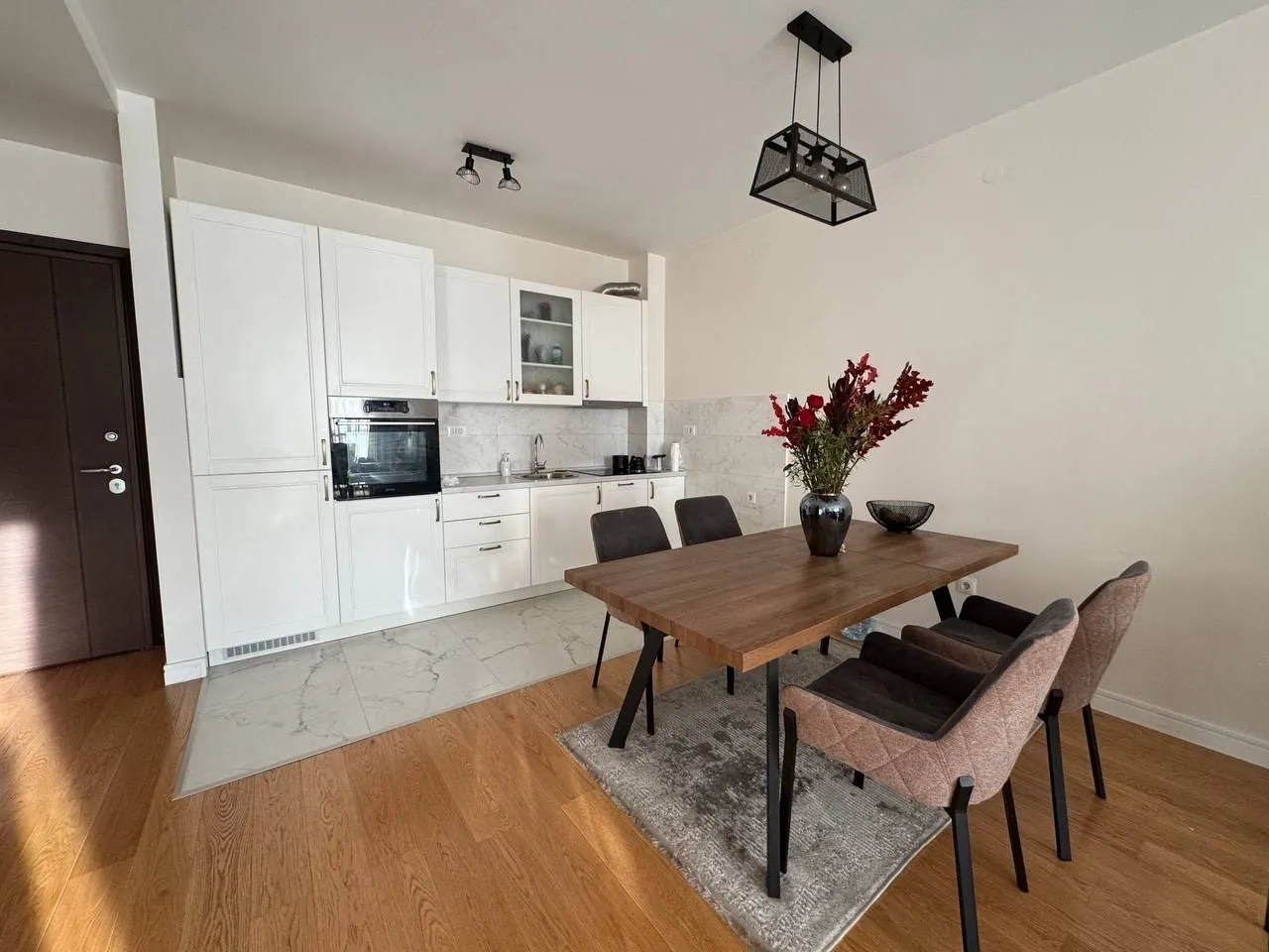 Bright kitchen with a dining table and chairs.