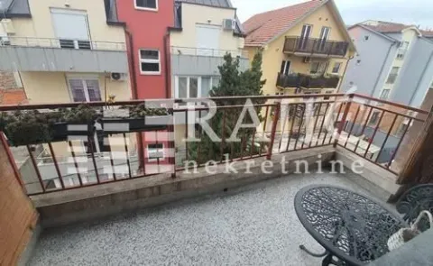 Small furnished balcony with a view of surrounding buildings. - image 9
