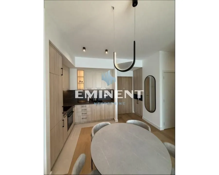 Modern kitchen with a dining table and built-in units.