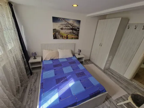Furnished bedroom with a double bed, wardrobe, and bedside tables. - image 10