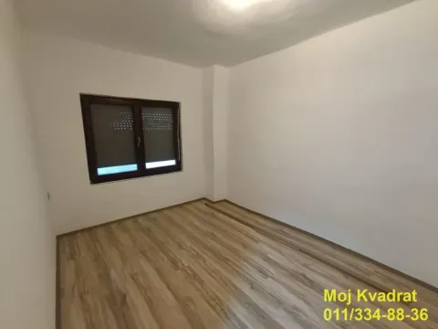 Empty room with white walls and wooden flooring. - image 5
