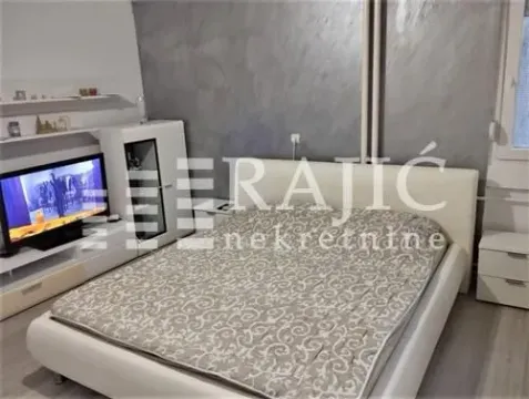 Bedroom with a double bed, television, and dresser. - image 4