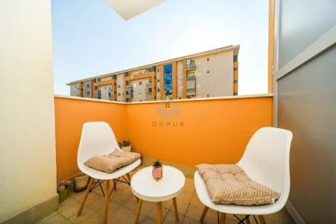 Furnished balcony with seating set and view of surrounding buildings. - image 6